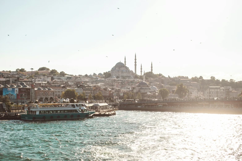 small boats floating on the water in front of a city