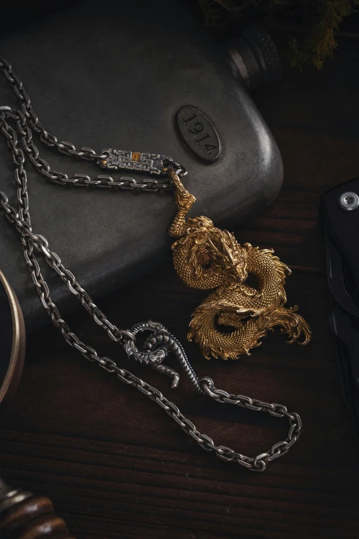 gold chains are arranged next to an old camera