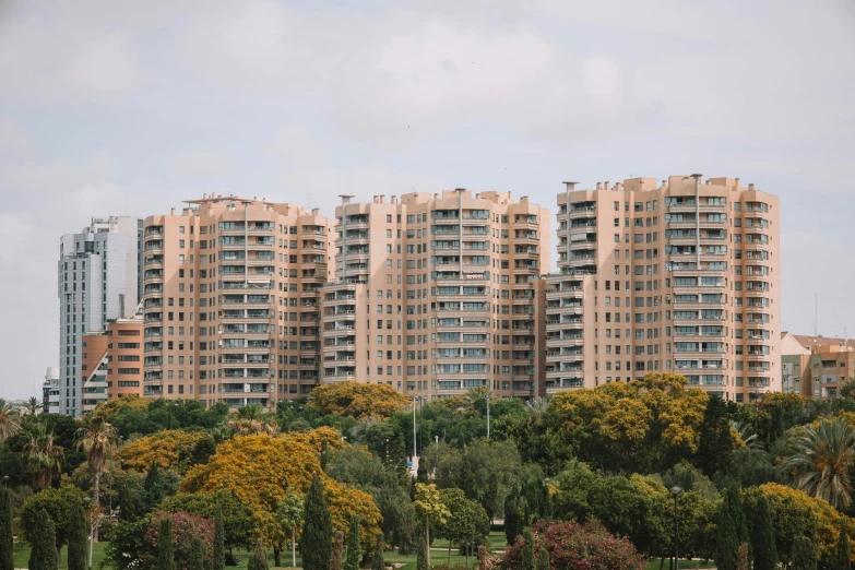 an apartment building is in the foreground with trees around it