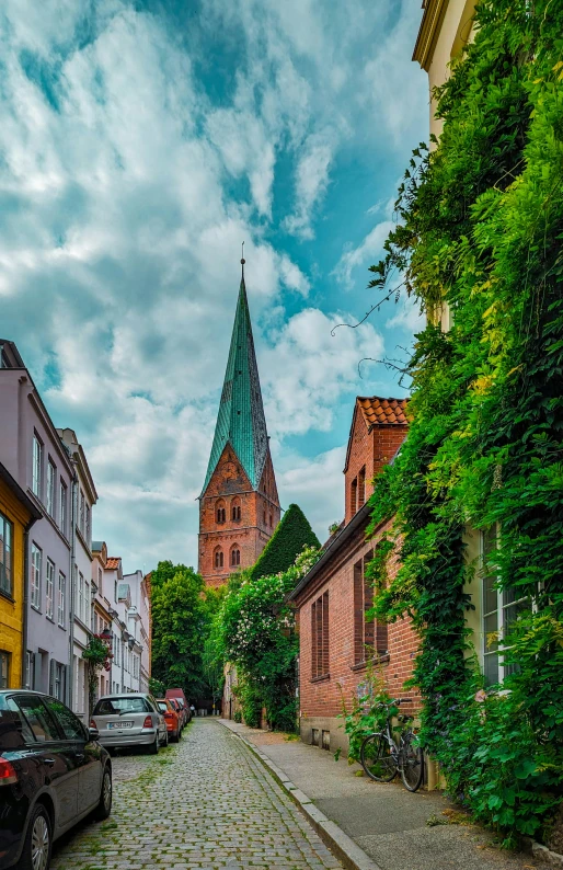 an old cobbled road lined with parked cars