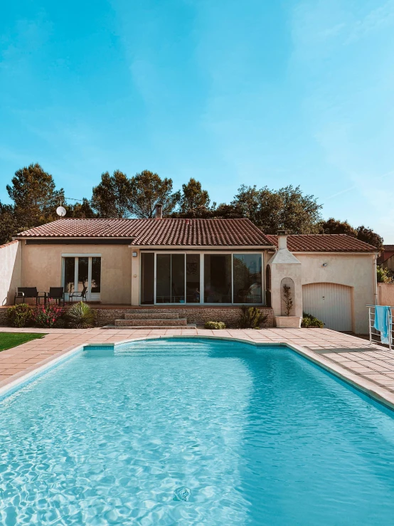 an image of a house that has a large swimming pool in it