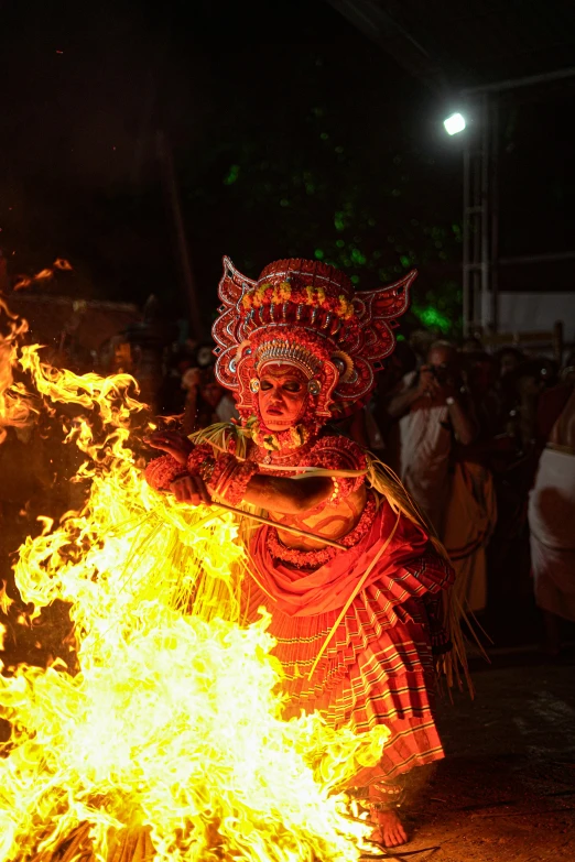 the performer is dressed in elaborately designed costume