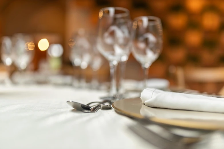 white table cloth with napkins and silverware