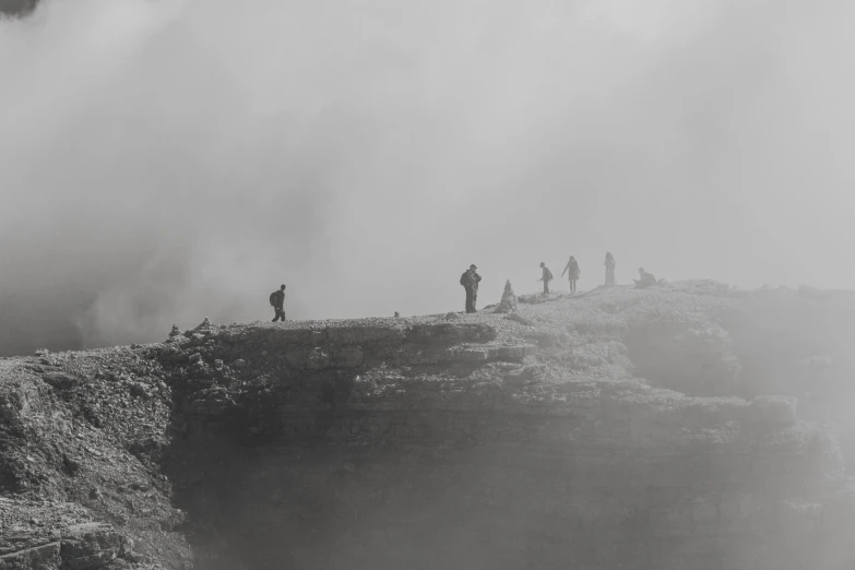 a group of people walking up the side of a steep cliff