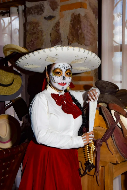 a woman in mexican makeup holding a knife