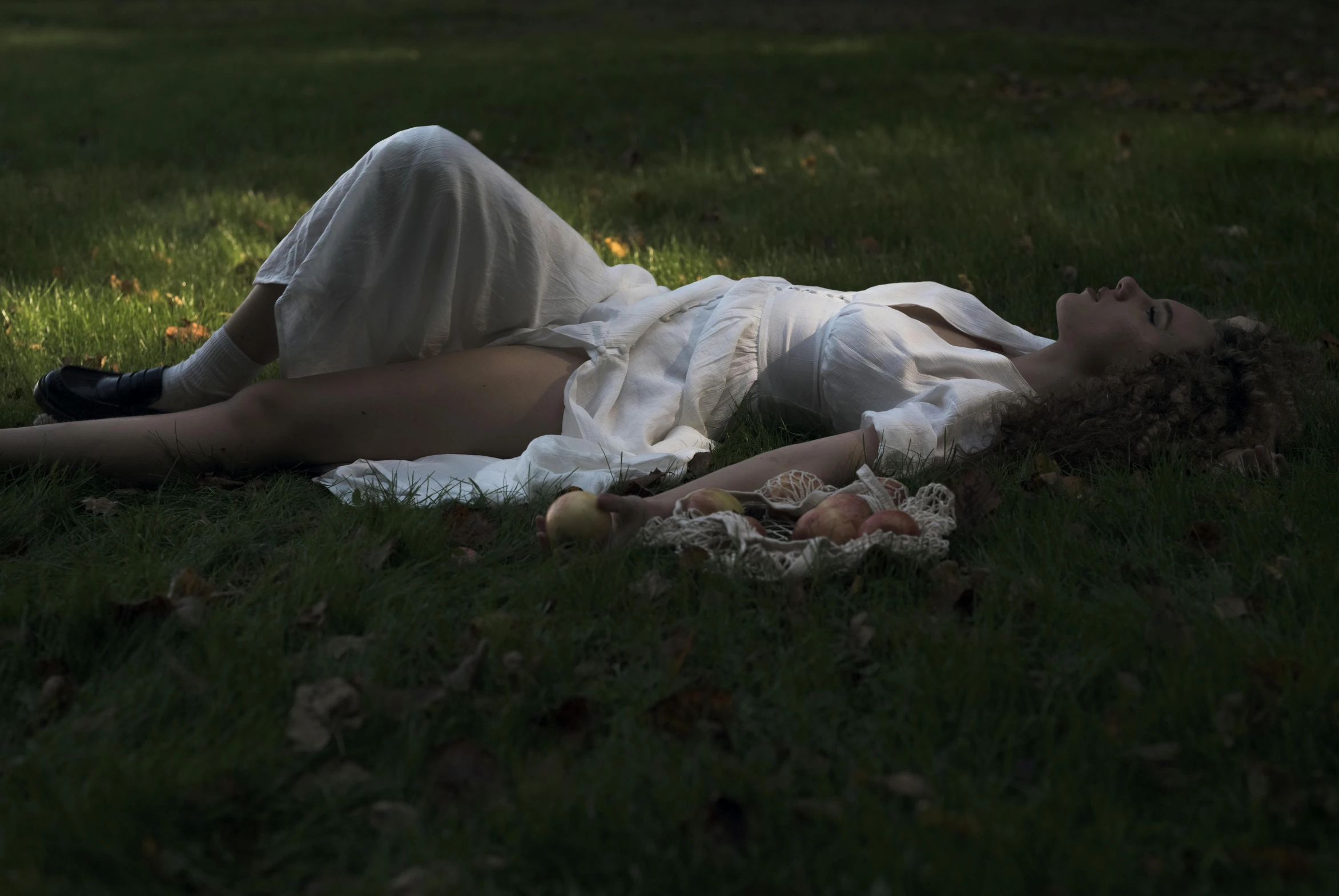 the woman is laying on her stomach in the grass