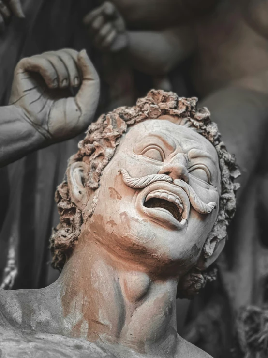 the head and shoulders of a sculpture with many hands