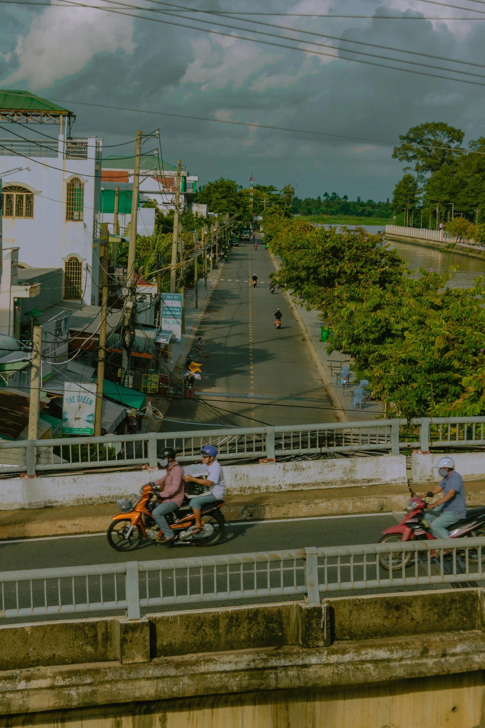 a group of bikers riding past people on their motor bikes