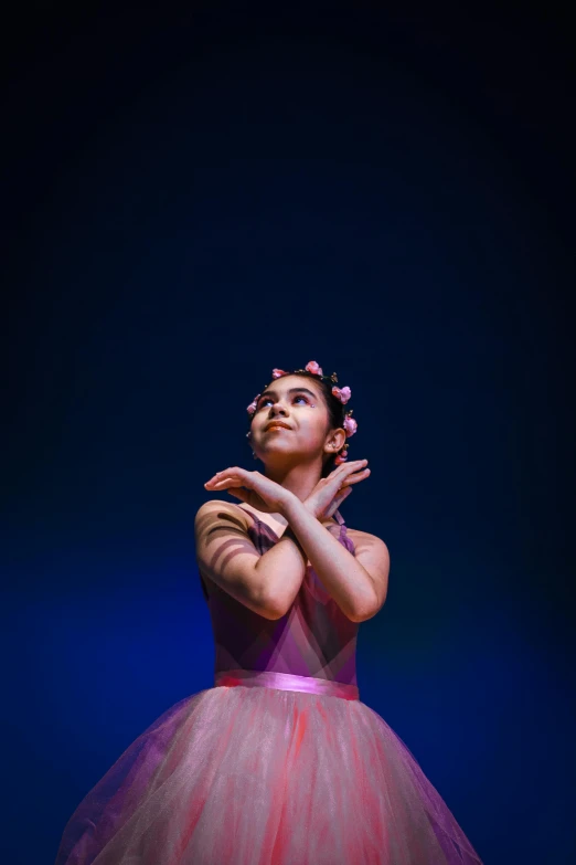 a woman in a ballerina dress with her hands to the side