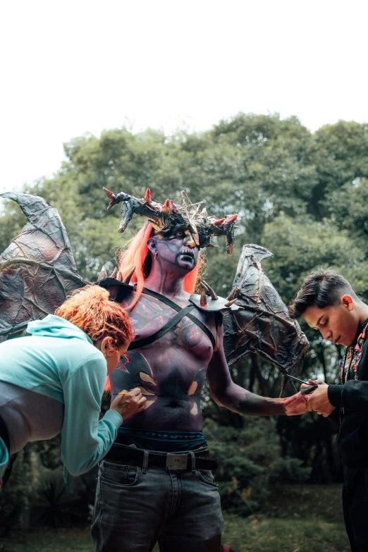 a couple of people with weird bodies standing in front of trees