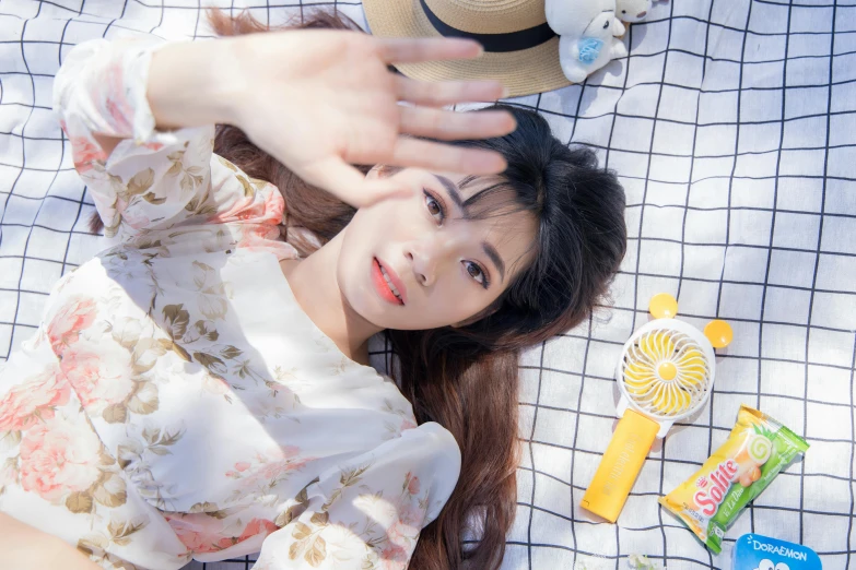 a woman lays on a blanket with her head on her hand