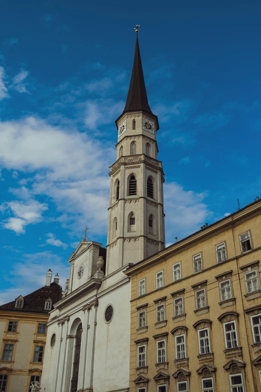 a tall clock tower near an older building