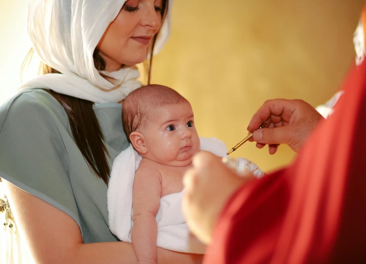 a baby is being held in her mom's arms