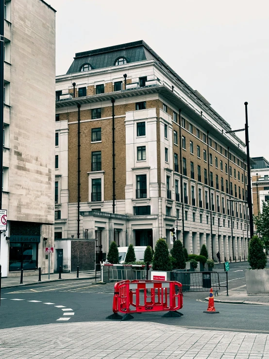 a building with three red sign stands behind the street