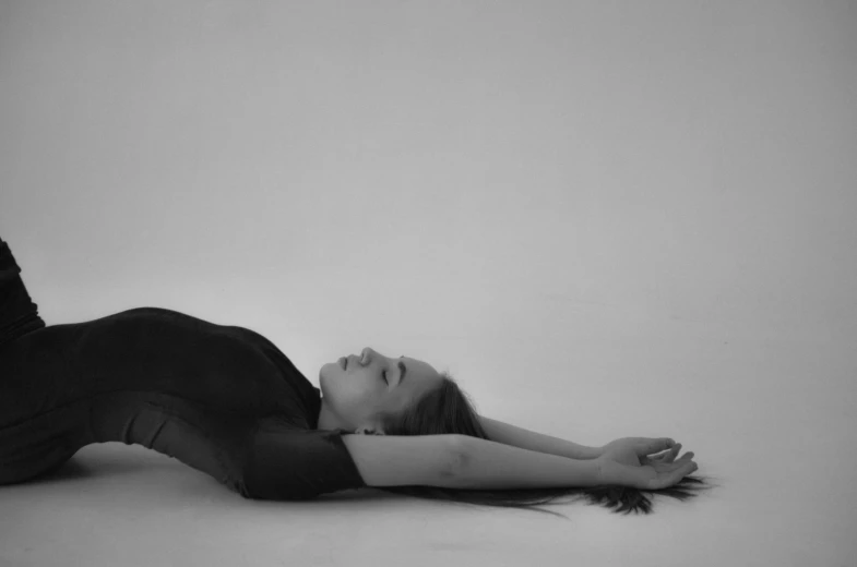 a woman laying down on the floor in her clothing