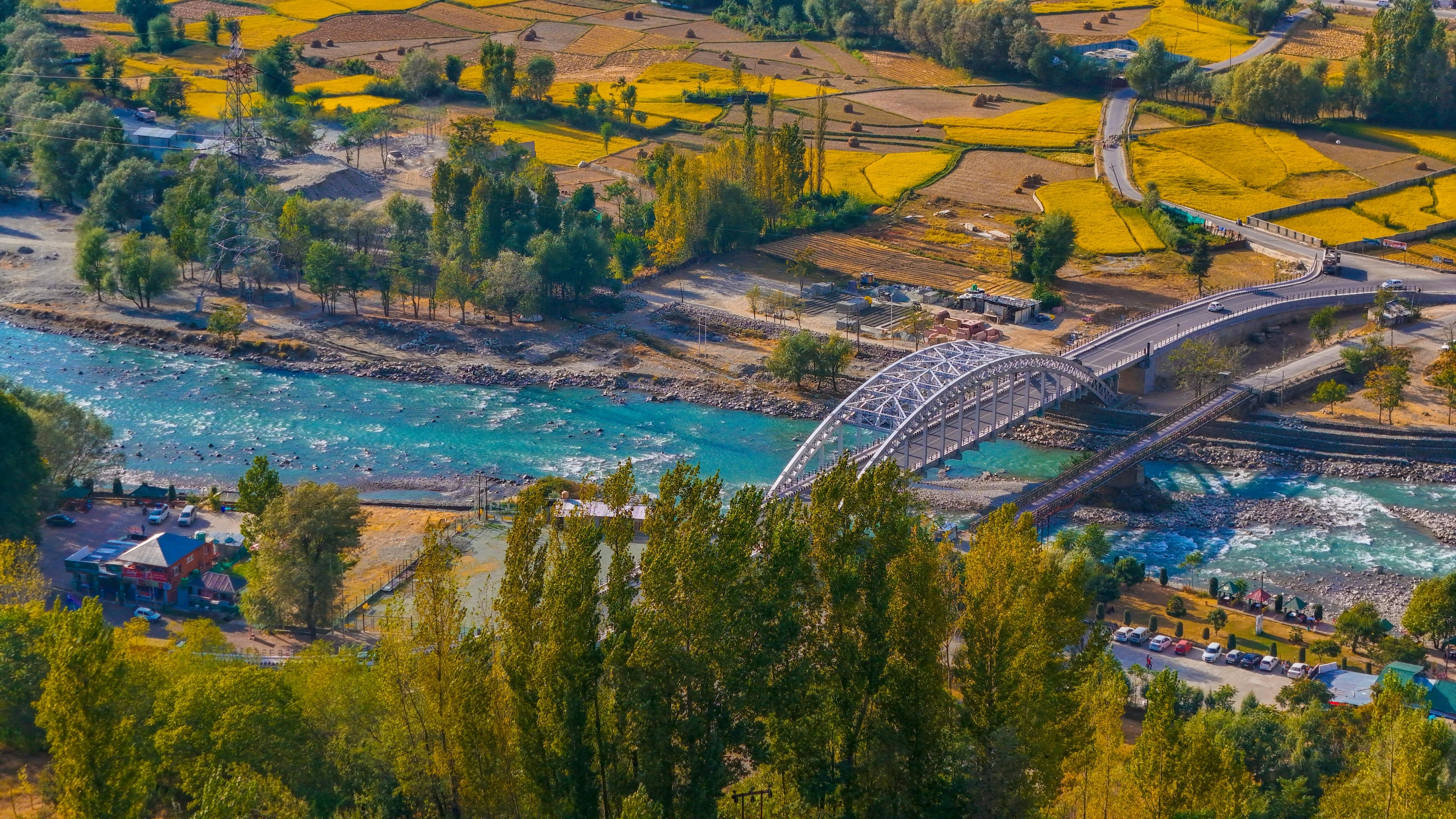 a bridge with cars crossing it over a river