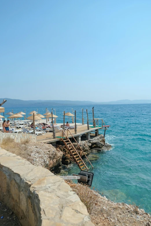 a wooden pier by the water on a sunny day