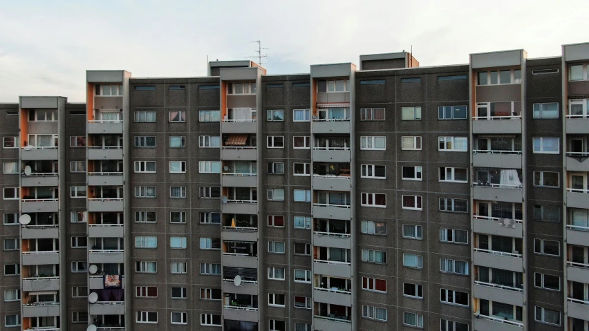 an apartment building's windows with curtains and balconies