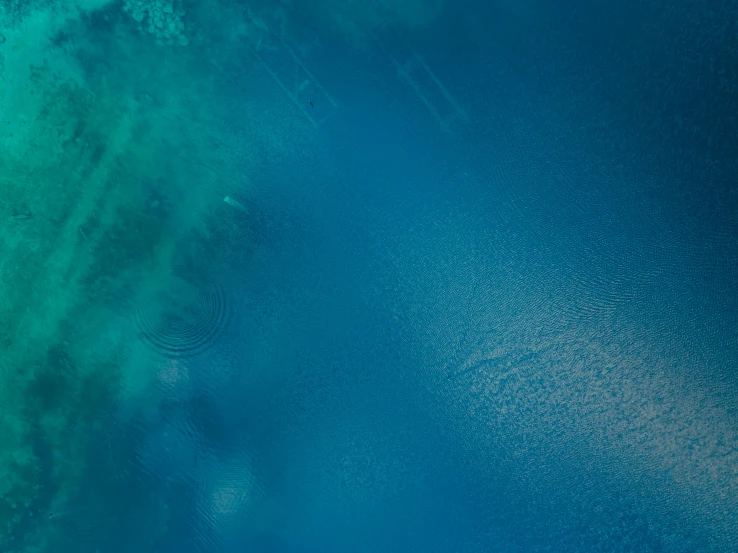 a large body of water that has many blue waves in it