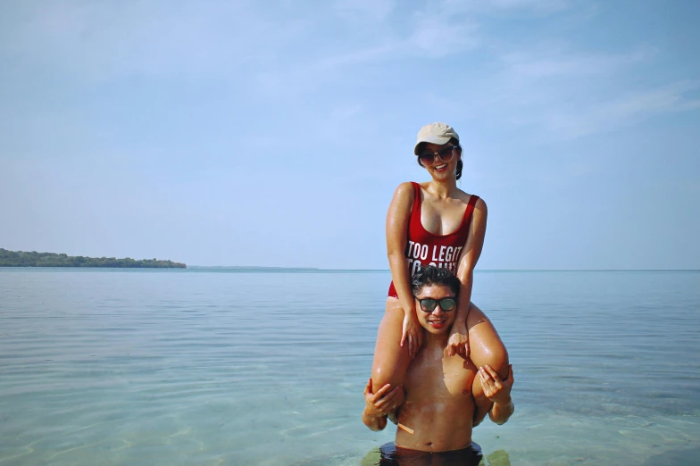 a man riding a woman on his back in the ocean