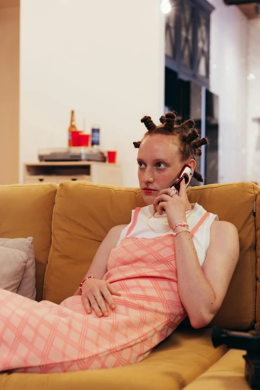 a girl laying on the couch with her hair sticking out