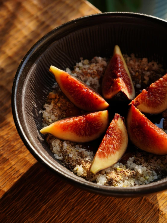 four sliced figs are placed inside of some porridge