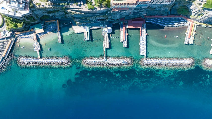 a pier is shown from the air, in the blue water