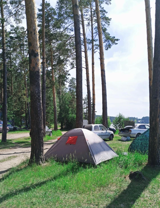 an outdoor camp ground with tents, camps and cars