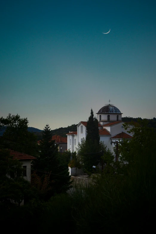 a few houses and some trees at dusk