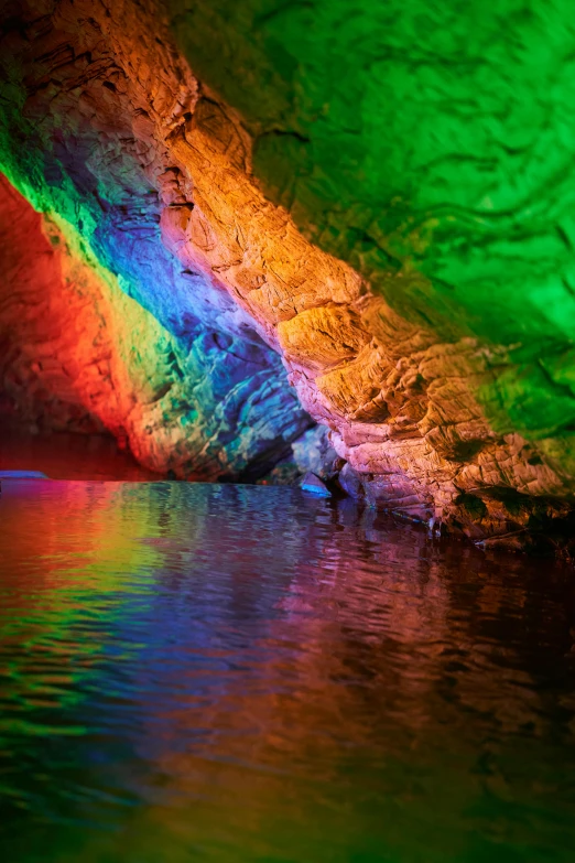 the colors of light reflected on a still pool of water