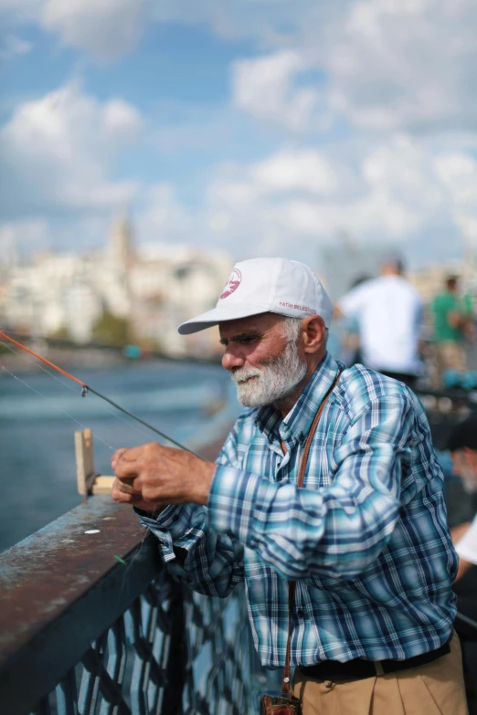 a man in checkered shirt fishing with hat