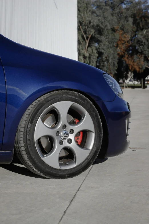 the wheels of a blue car parked on the street