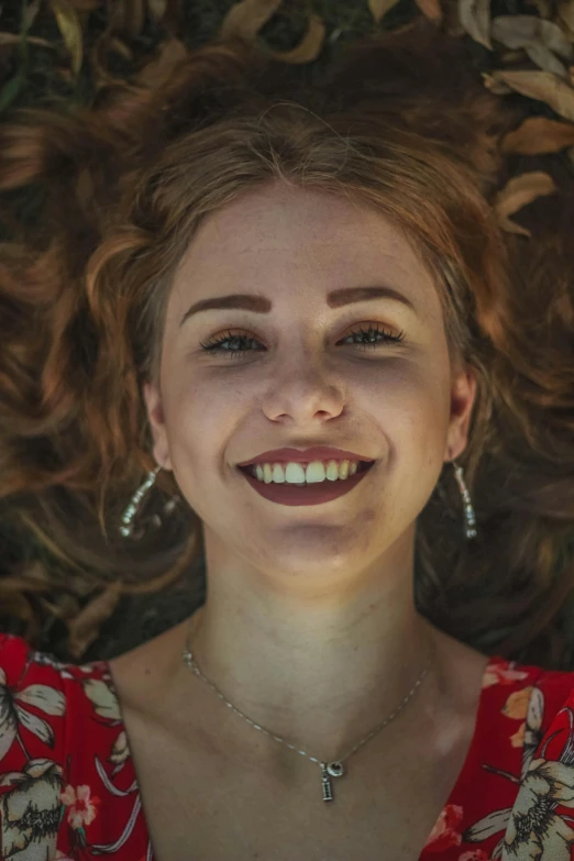 a girl smiling while lying down with her eyes closed