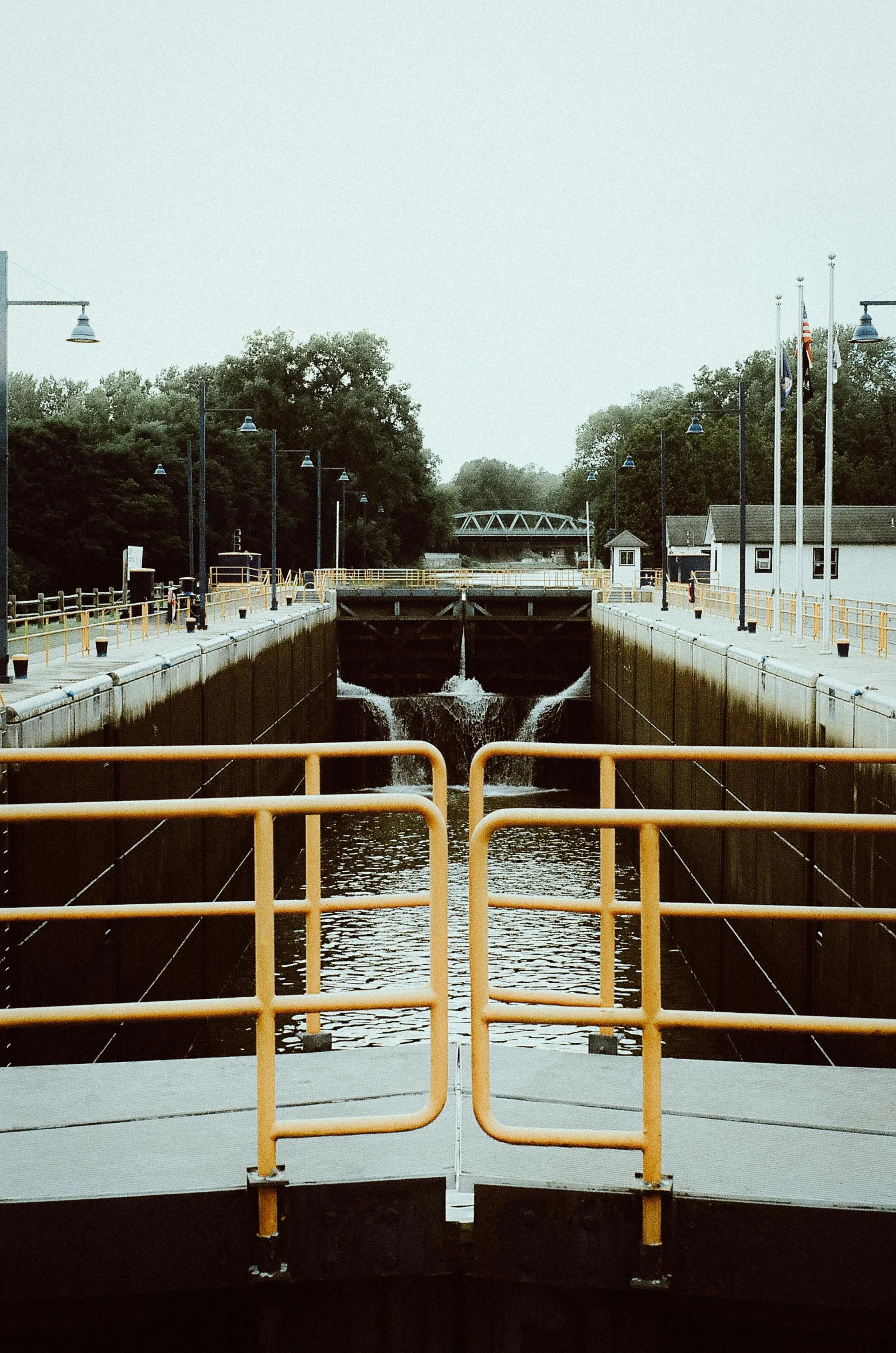 an orange gate is next to the entrance to the lock