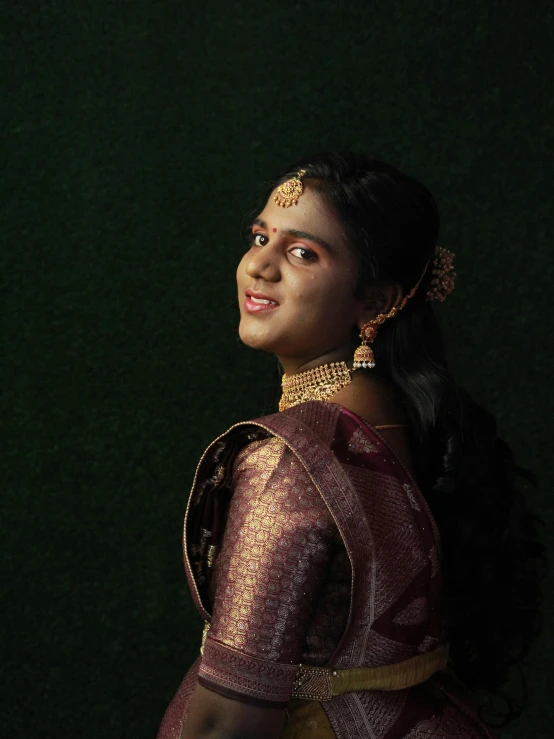 a woman in an indian traditional dress is staring away