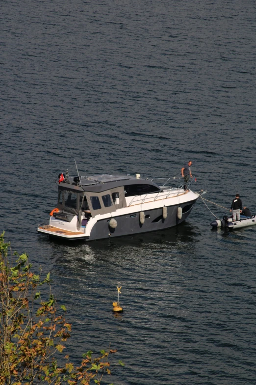 people standing on top of a motor boat in the middle of the water