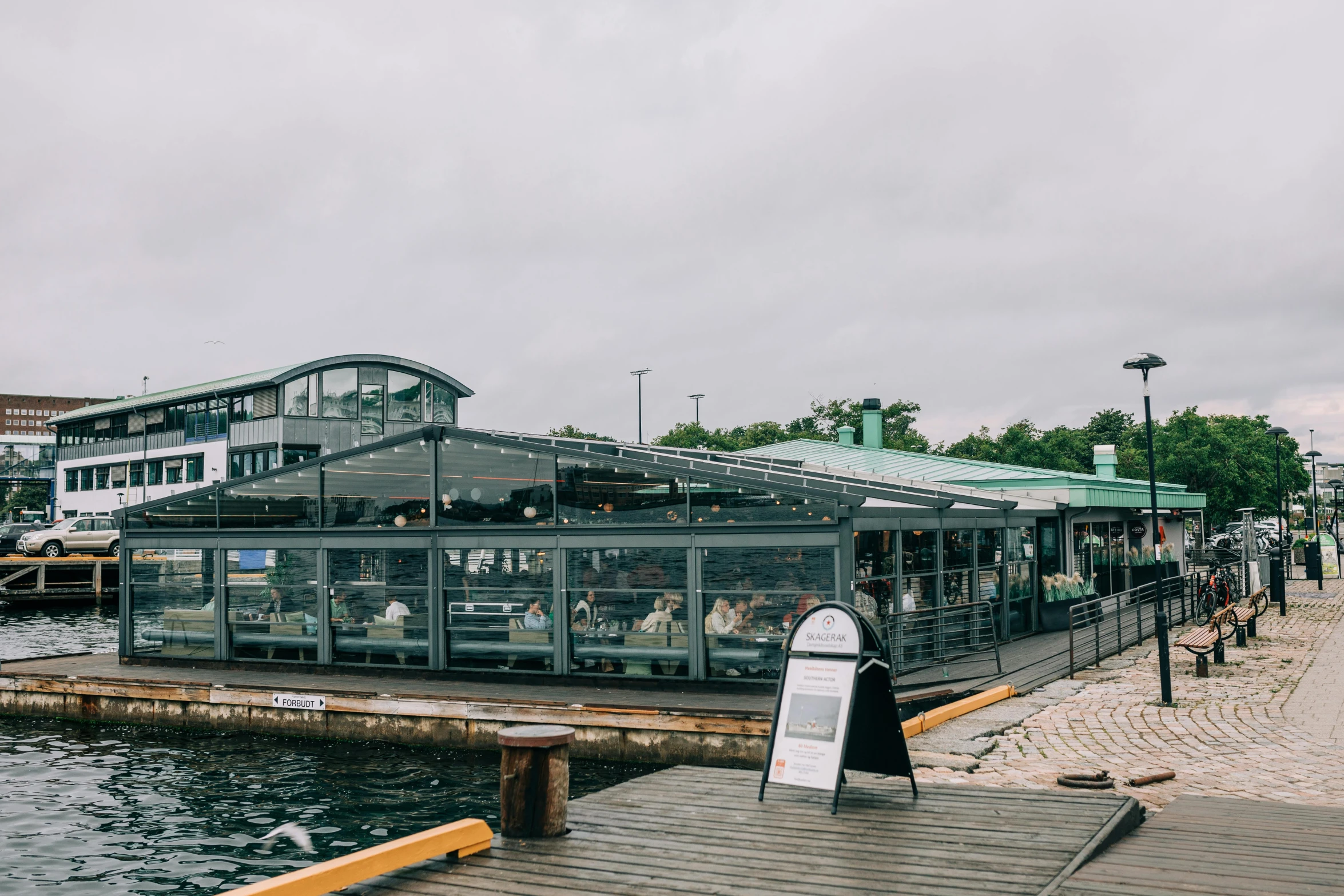 a small cafe sits at the end of a dock