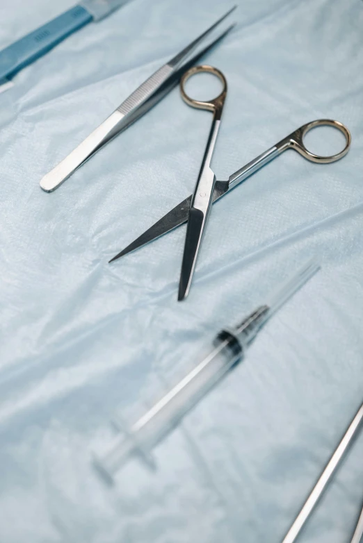 there are several pairs of surgical scissors on the bed