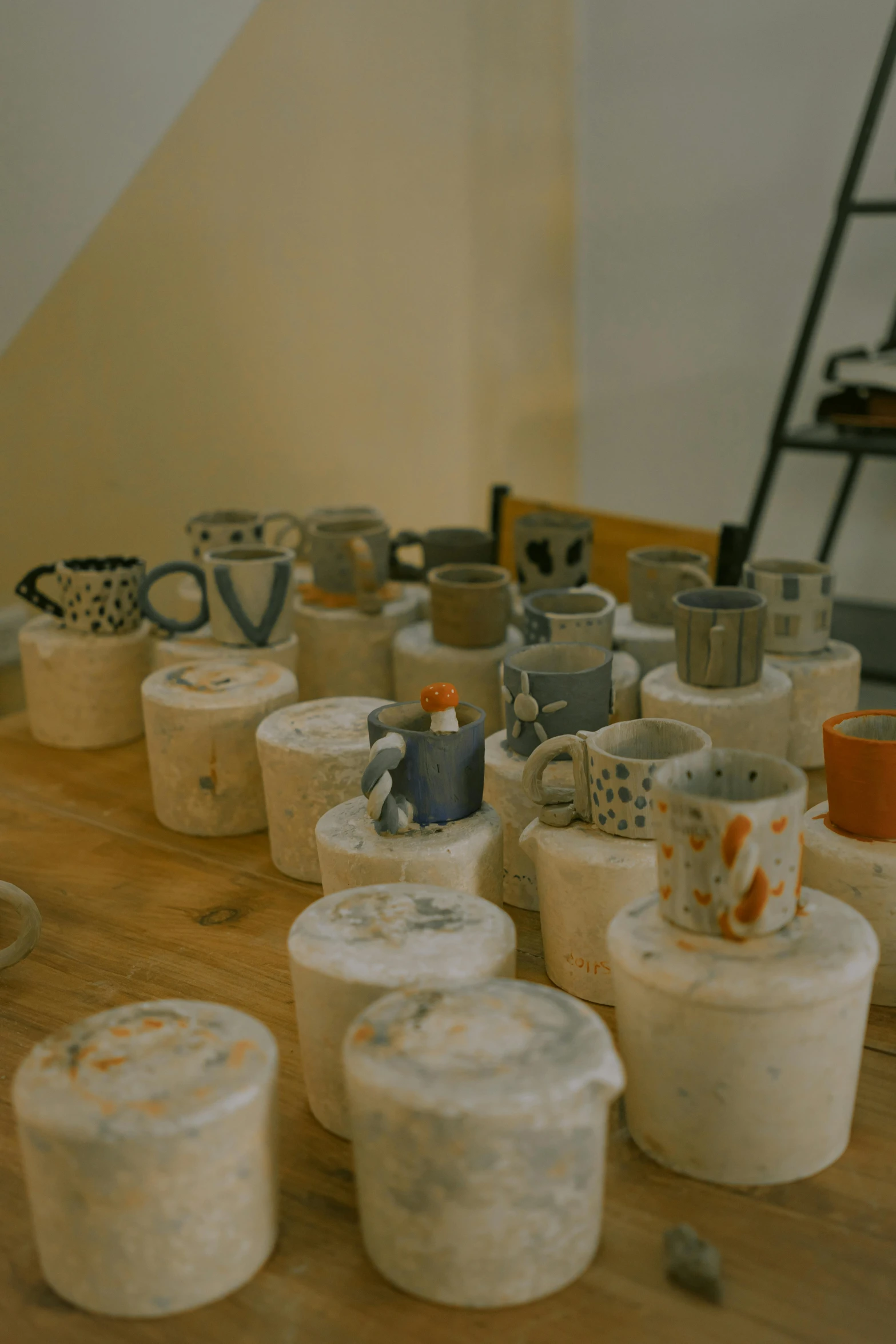 several stacks of pottery pots on a wooden table