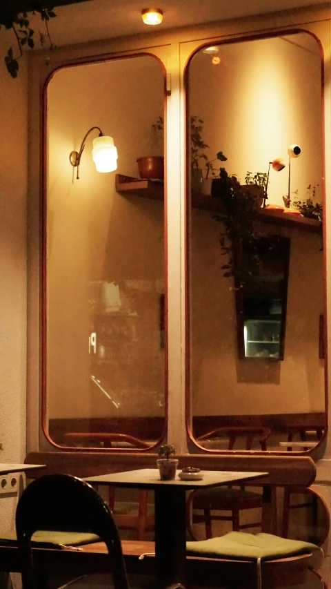 some mirrors hanging in the middle of a cafe