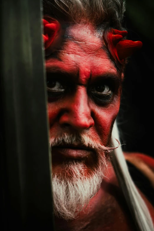 a man with horns and makeup on his face