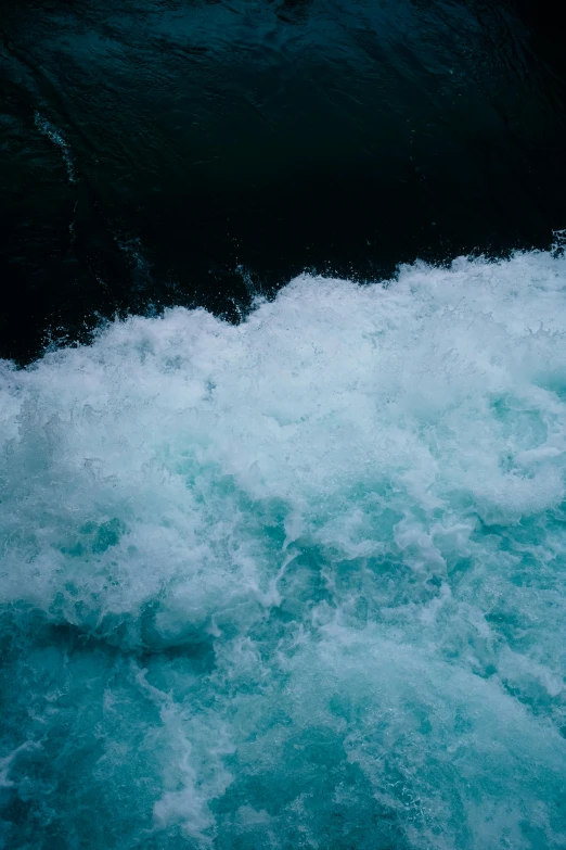 water with white foam coming off the side of it