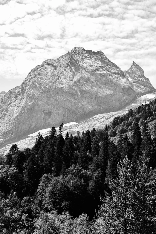 a mountain is shown under a cloudy sky