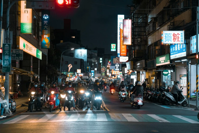 several motorcycles driving down a busy city street