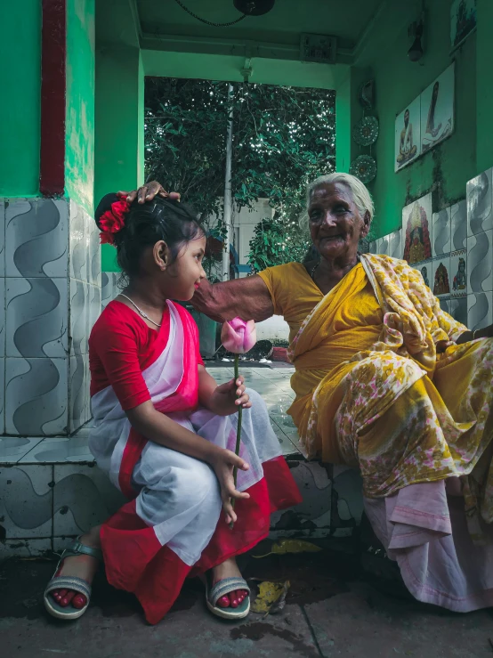 a man handing a flower to two women