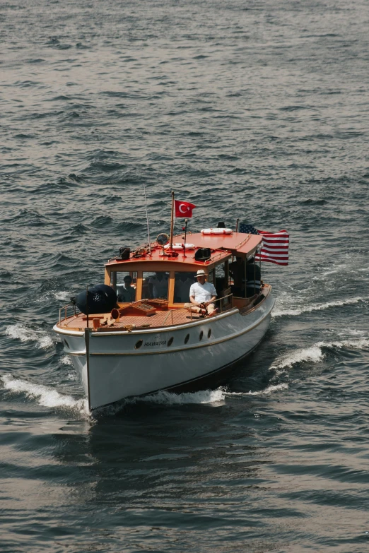 a white and orange boat floating on a body of water