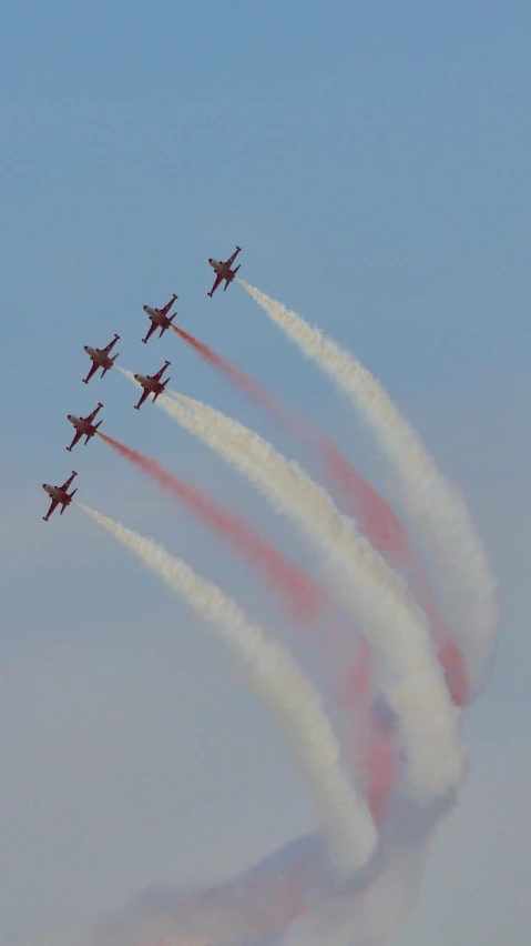 a group of jets flying through the sky