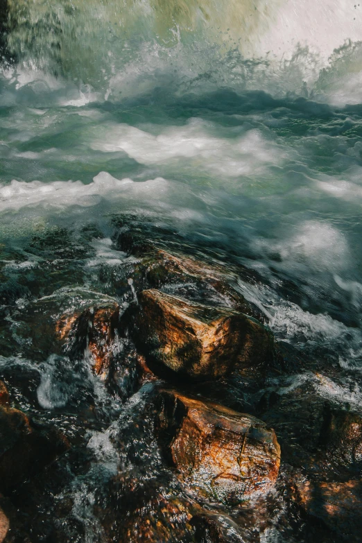 there is an oil painting of some rocks in the water