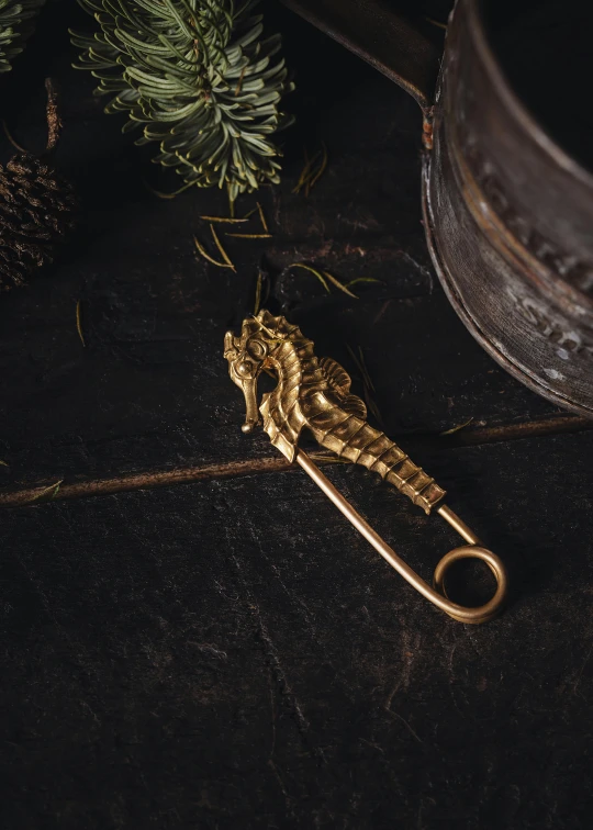 gold - colored metal scissors sitting on top of a black table