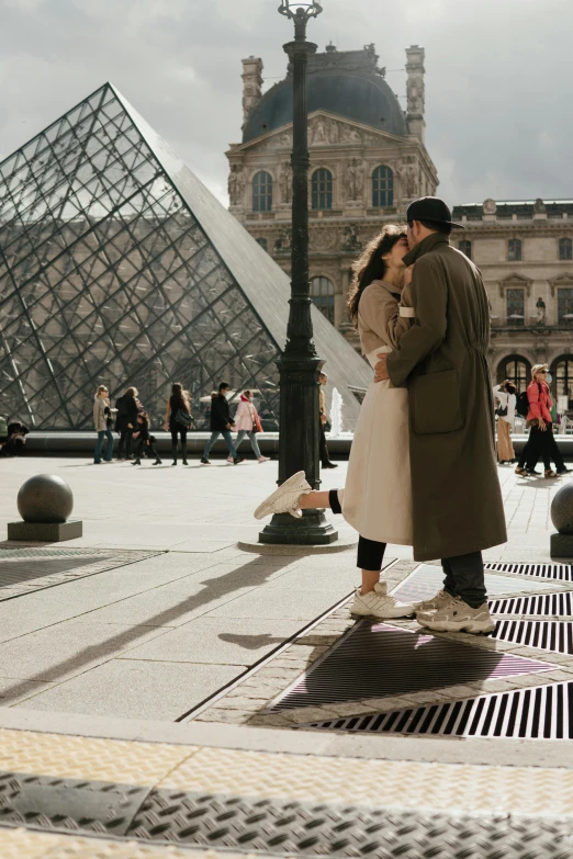 a couple posing in front of the pyramid